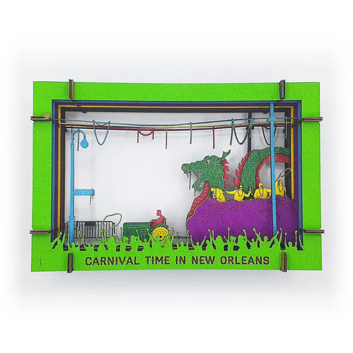 Decorative sign with a cartoonish scene of a parade featuring a dragon and people, set against a green border with 'Carnival Time in New Orleans' text. Banko Box