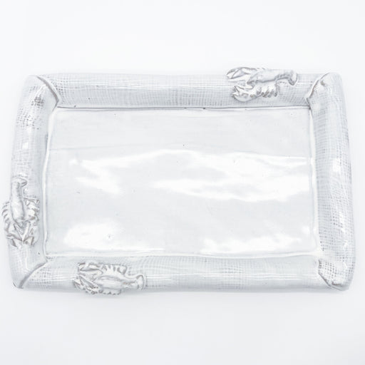 A rectangular clear glass serving tray with a textured silver rim featuring sculpted crawfish details on each corner, shown on a plain white background.